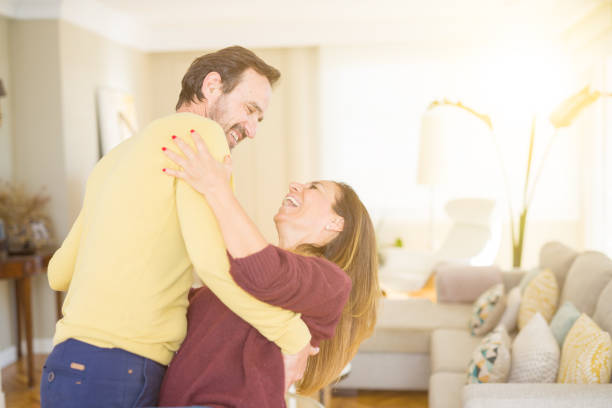 istock Romantic middle age couple dancing together in love at home 1139693003