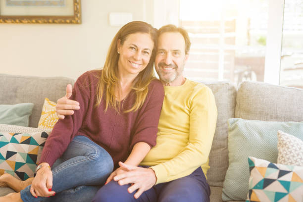 istock Middle age romantic couple sitting on the sofa at home 1139693060