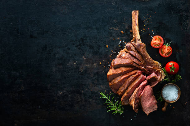Grilled dry aged tomahawk steak sliced as close-up