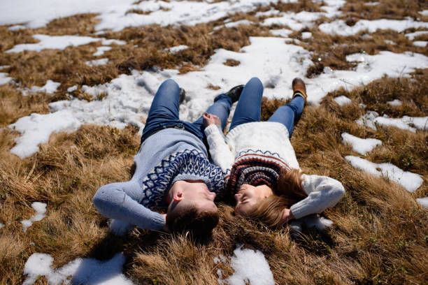 istock Young couple relaxing on the snow 1139694608