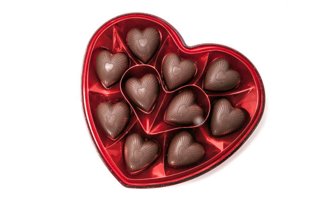 Heart shaped box of chocolate candy Heart shaped box of Valentine's chocolate candy isolated on white heart shape valentines day chocolate candy food stock pictures, royalty-free photos & images