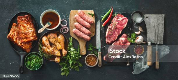 Various Kinds Of Grill And Bbq Meats With Vintage Kitchen And Butcher Utensils Stock Photo - Download Image Now