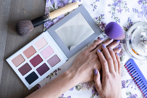 Female hands on table, beauty products.