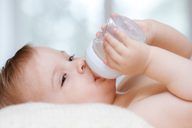 istock Kid drinks compote from a bottle at home 1139696135