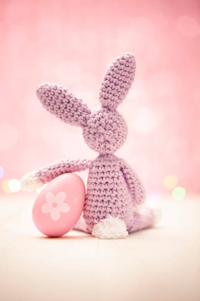 istock Cute homemade Easter bunny with egg on a pastel pink background - Spring Rabbit 1139696722