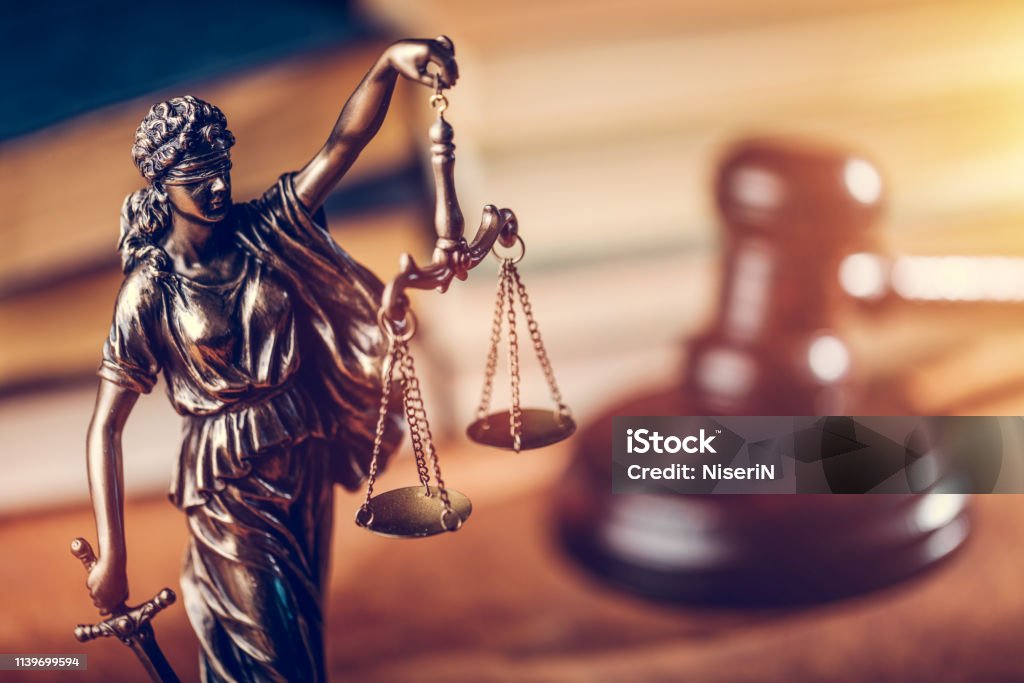 Law concept - Themis statue, judge hammer and books. Law and justice concept - Themis statue, judge hammer and books. Courtroom. Law Stock Photo