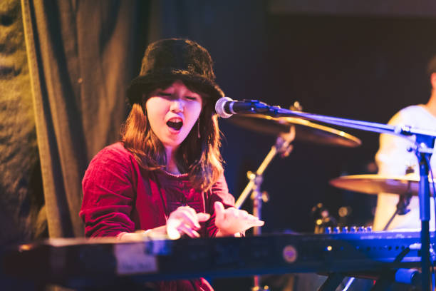 istock Woman Playing Electronic Keyboard At Live Event 1139700159