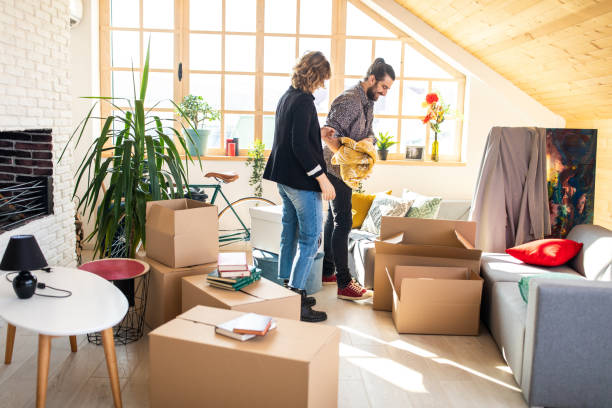 istock Couple unpacking boxes in new apartment 1139702608