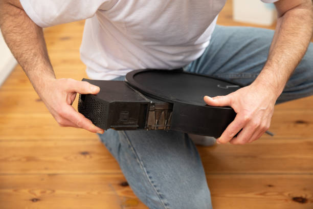 istock Robotic vacuum cleaner maintenance 1139702823