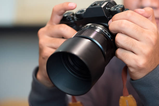 istock Photographer holding mirrorless camera for check his photo in selective focus. 1139703330