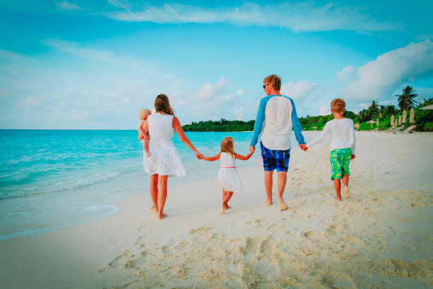 istock happy family with three kids walk on beach 1139706637