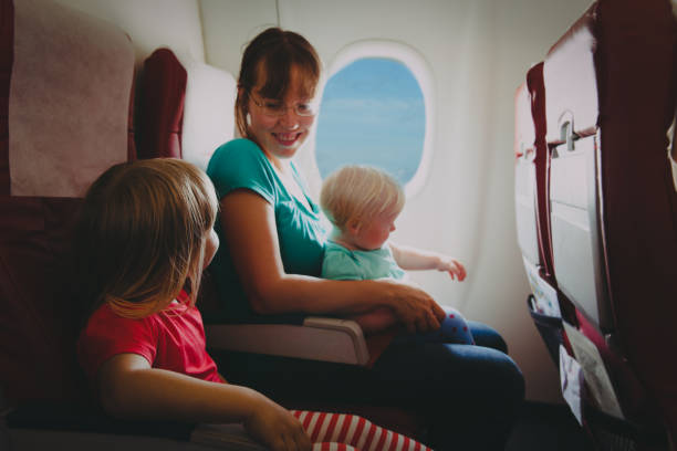 istock mother with two kids travel by plane 1139707410