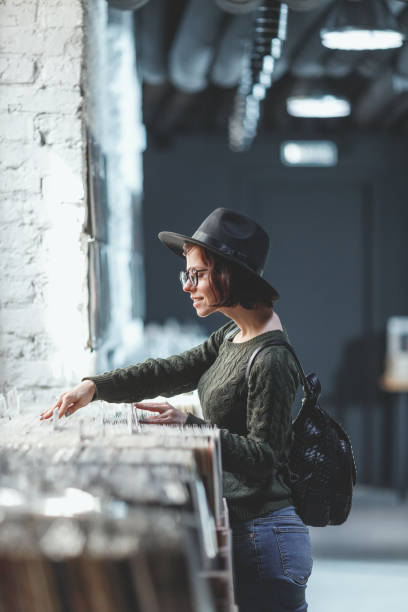 istock Young girl browsing records in a store 1139707864