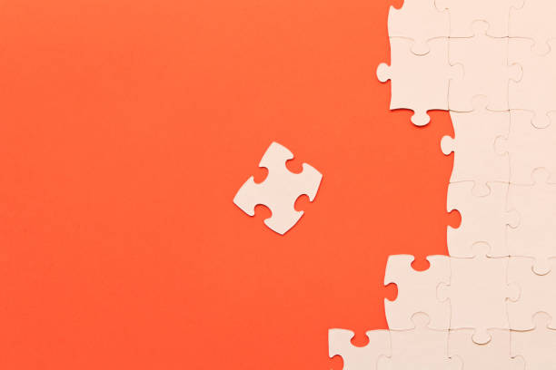 istock White jigsaw puzzles on red background. The concept of development of thinking. 1139711315