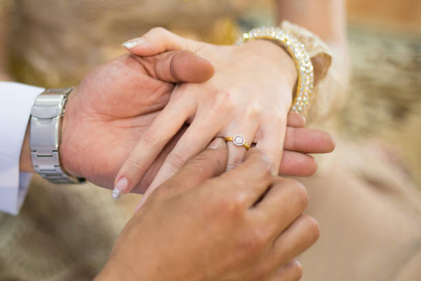 istock groom wears ring on bride's finger in wedding ceremony 1139712459