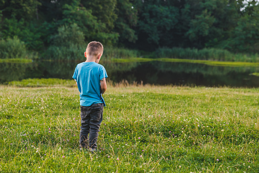 little offended boy standing away alone. copy space