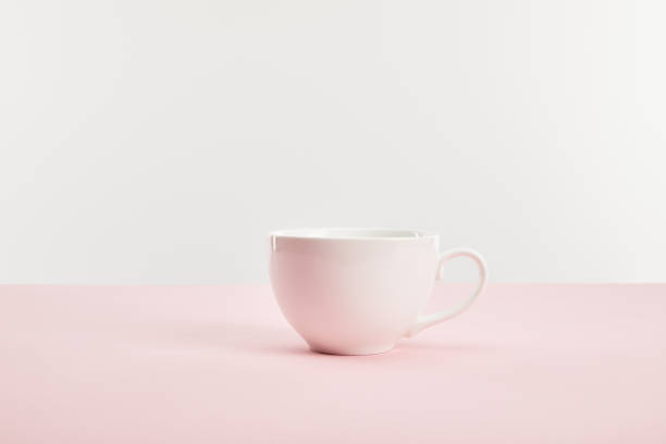 istock white cup with drink on pink surface isolated on grey 1139713805