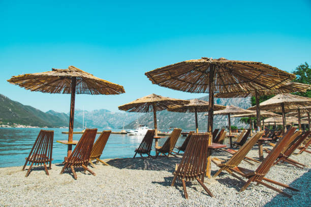 istock empty beach with sun loungers and umbrellas. sea with mountains 1139714115