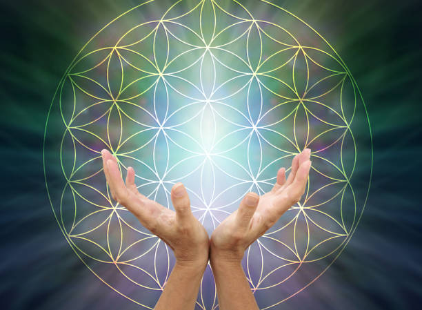 The Flower of Life Mandala Female cupped hands reaching up inside the flower of life symbol pattern against a light to dark green radiating background with copy space above reiki photos stock pictures, royalty-free photos & images