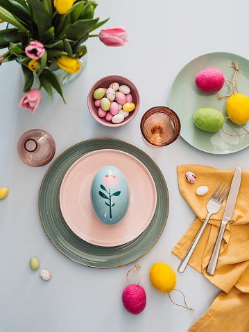 Easter table setting with cutlery plates dinnerware easter egg
Pastel colored photo taken from above overhead