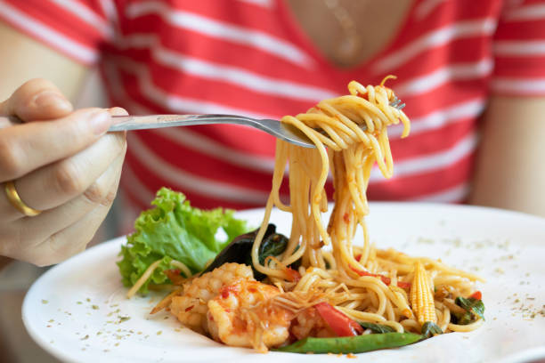 woman eating spaghetti spicy seafood