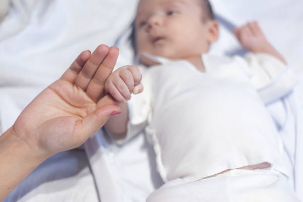 istock mother and newborn baby hands 1139717649
