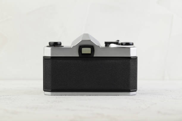 istock The old 35 mm SLR camera on white cement background. 1139718691