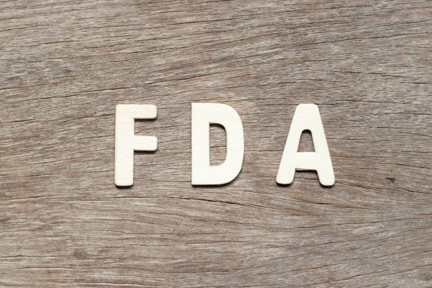 Alphabet letter in word FDA (abbreviation of food and drug administration) on wood background Alphabet letter in word FDA (abbreviation of food and drug administration) on wood background food and drug administration photos stock pictures, royalty-free photos & images
