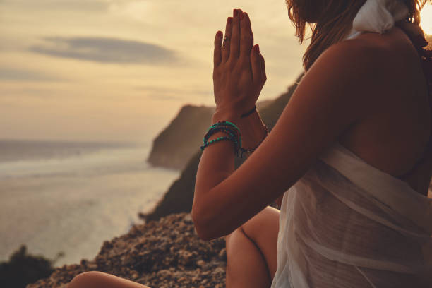 istock Young woman practicing yoga - meditation on the beach. 1139721110