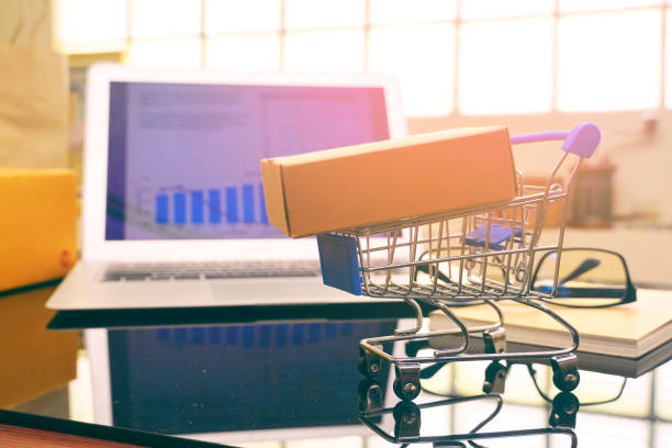 istock Packaging box on shopping cart with background computer screen,online shopping concept. 1139722463