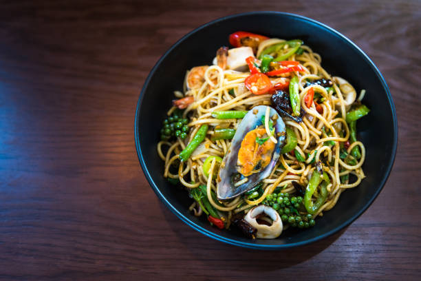 istock Spicy Spaghetti with Seafood in black dish on wooden table 1139722676