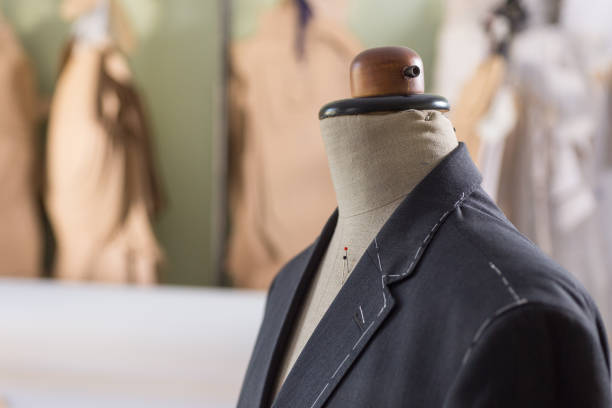 istock Tailored suit jacket with alterations marked with basting stitch on a mannequin at bespoke tailor's workshop. 1139724588