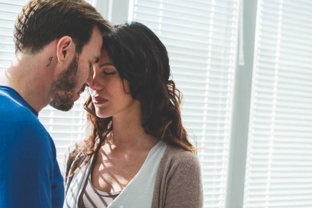 istock Serious couple with eyes closed standing face to face 1139724693
