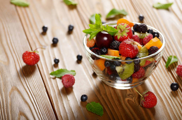 istock Assorted fruits in glass bowl on kitchen wooden table 1139725319