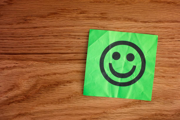 istock Paper with happy face on wooden background 1139725379