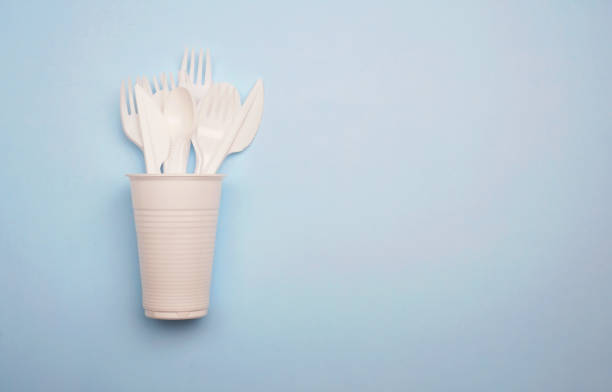 istock Single-use plastic products: plastic cutlery, cups on bright blue background 1139726483