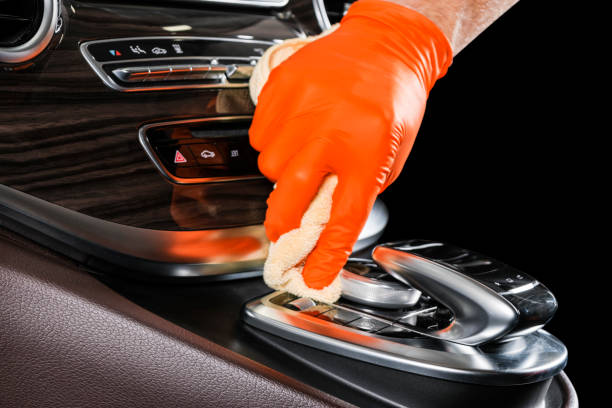 A man cleaning car with microfiber cloth. Car detailing or valeting concept. Selective focus. Car detailing. Cleaning with sponge. Worker cleaning. Car wash concept solution to clean stock photo