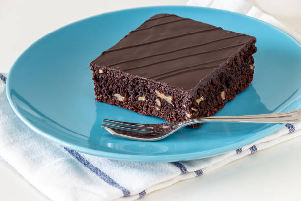 istock Homemade dark chocolate vegan brownie cake with nuts blue plate light background. Selective focus. Close up. 1139728850