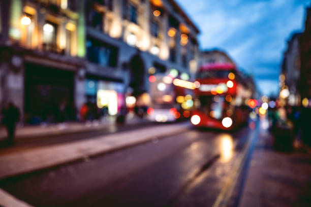 London typical red bus blurred motion at night in Oxford Circus