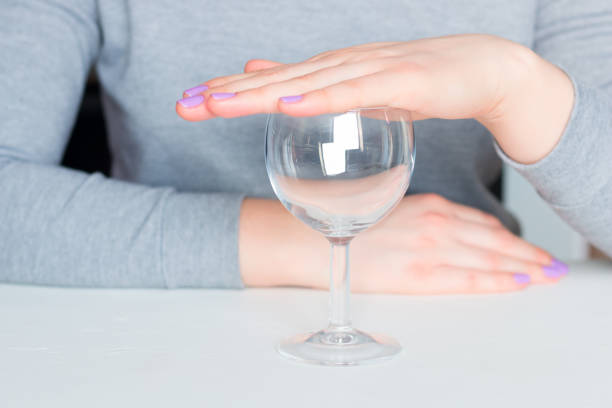 young woman and empty glass - refusal of alcohol young woman and empty glass - refusal of alcohol sobriety stock pictures, royalty-free photos & images