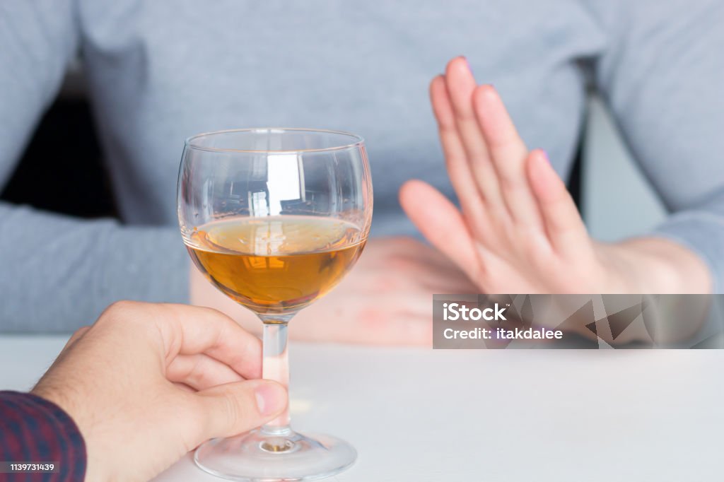 man offer alcohol but woman refuses Alcohol - Drink Stock Photo