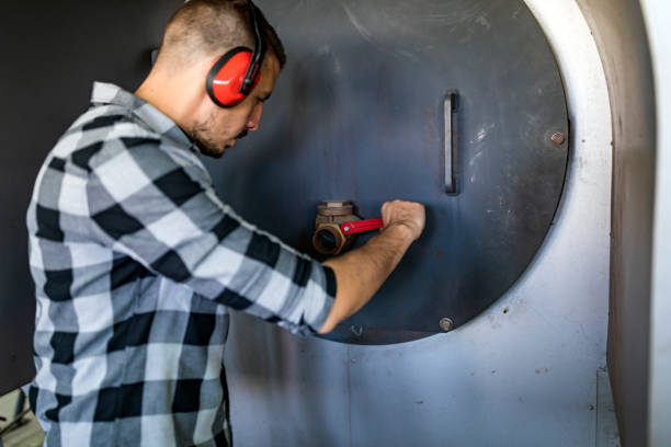 istock Young Technician is Inspecting Heating System in Boiler Room 1139731716