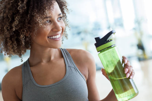 taking a drink of water at the gym - water bottle water bottle drinking imagens e fotografias de stock