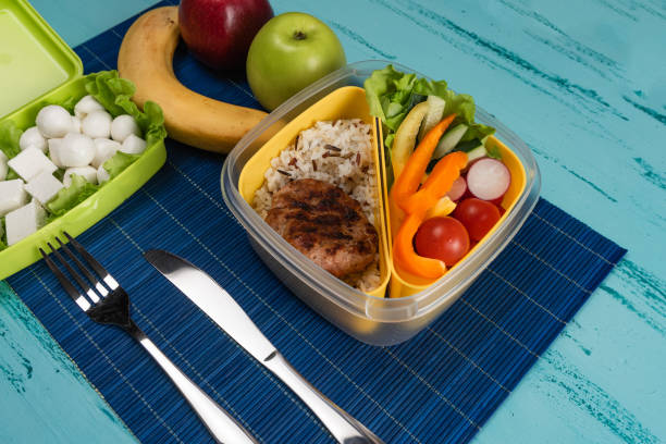 istock Lunch box with appetizing food and on light wooden table. Copy space. 1139732137