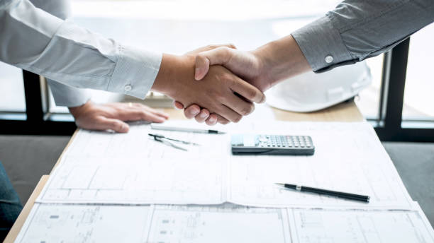 istock Handshake of collaboration, Construction engineering or architect discuss a blueprint and building model while checking information on sketching, meeting for architectural project of partner 1139733094