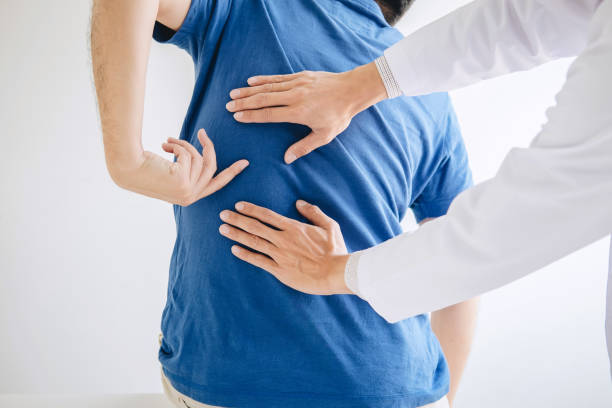 istock Doctor physiotherapist treating lower back pain patient after while giving exercising treatment on stretching in the clinic, Rehabilitation physiotherapy concept 1139733204