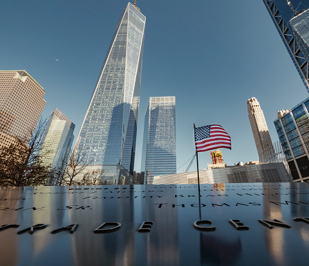 New York City United States of America January 24th 2019 : The National September 11 Memorial & Museum. This memorial of the 9/11 terrorist attacks is located where the Twin Towers stand in the past. Behind is the Freedom tower the tallest building in United States