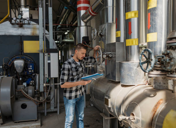istock Young Technician is Inspecting Heating System in Boiler Room 1139734342