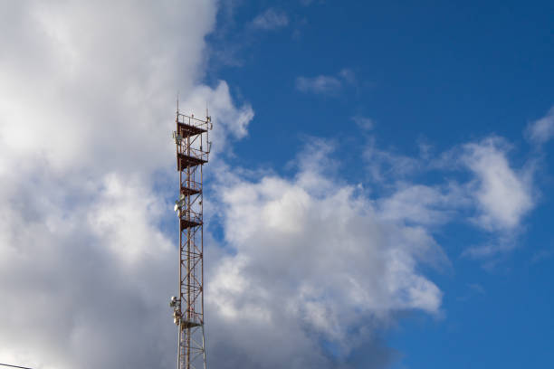 Antenna tower with blue sky and cloud background