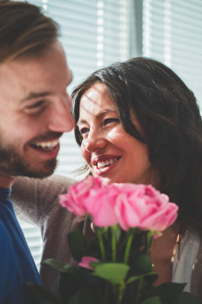 istock Smiling man and woman with roses 1139737143